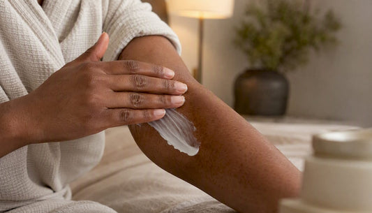 Close-up of applying body cream on uneven skin