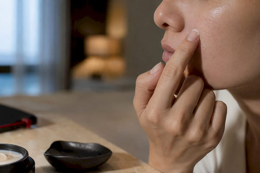 Fingertip applying butter to dry facial patch