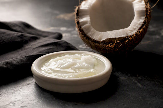 Coconut oil beside an opened coconut