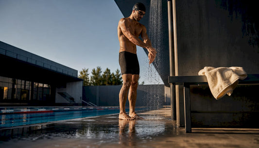 Swimmer rinsing arms beside pool