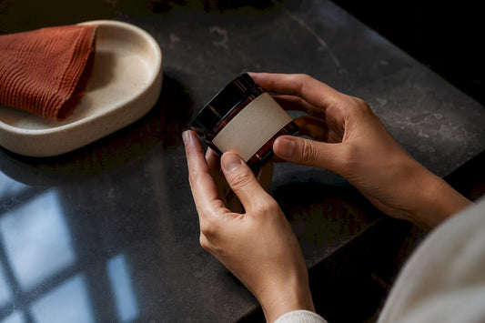 Hands inspecting a cosmetic ingredient label