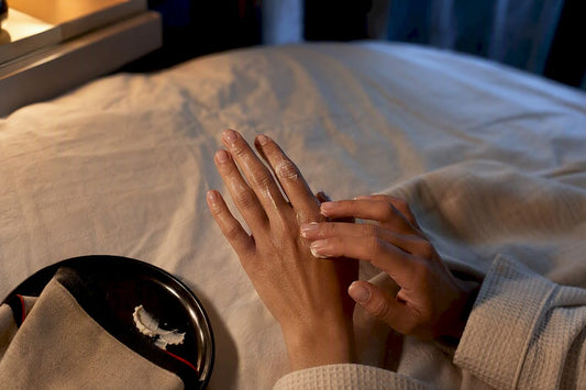 Hands massaging body butter into dry knuckles